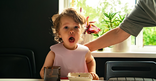 Toddler showing signs of choking while eating, highlighting the dangers of choking.